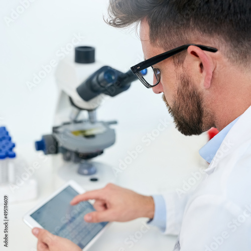 Technology helps facilitate cutting-edge medical development. Cropped shot of a male scientist working on a digital tablet in a lab.