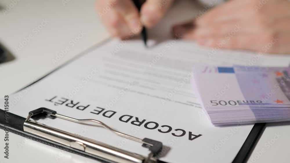 loan agreement in French-speaking languages. Banker woman hands sign loan terms, repayment terms and monthly payment. A woman borrows money, a credit card. loan agreement in French-speaking languages. Banker woman hands sign loan terms, repayment terms and monthly payment. A woman borrows money, a credit card.