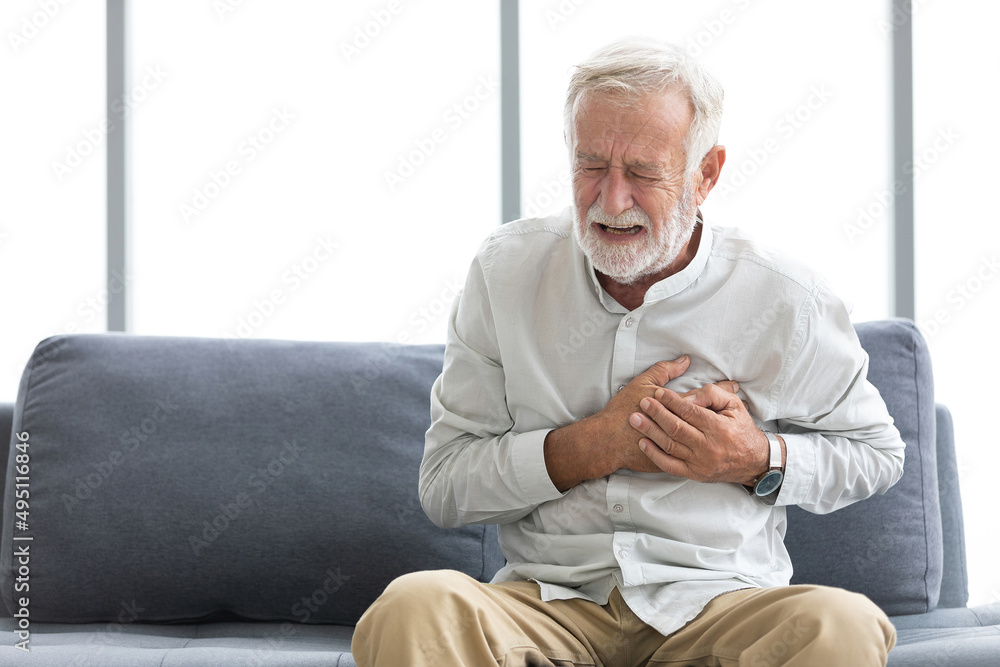 senior elderly man chest pain or suffering from heart attack on a sofa senior elderly man chest pain or suffering from heart attack on a sofa