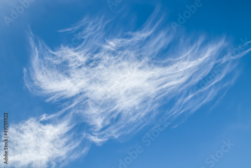 Beautiful fluffy clouds on a blue sky as a background.