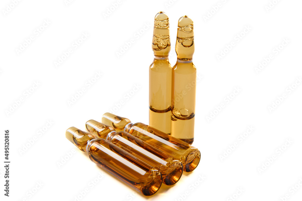 Three dark glass ampoules with medicine, isolated on a white background. Three dark glass ampoules with medicine, isolated on a white background.