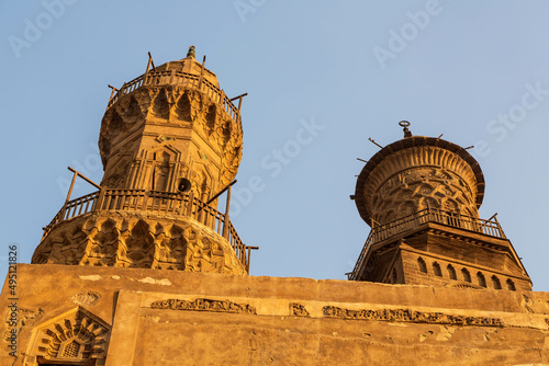Towers and minarets of Qalawun complex in Islamic Cairo at sunset. Cairo, Egypt photo