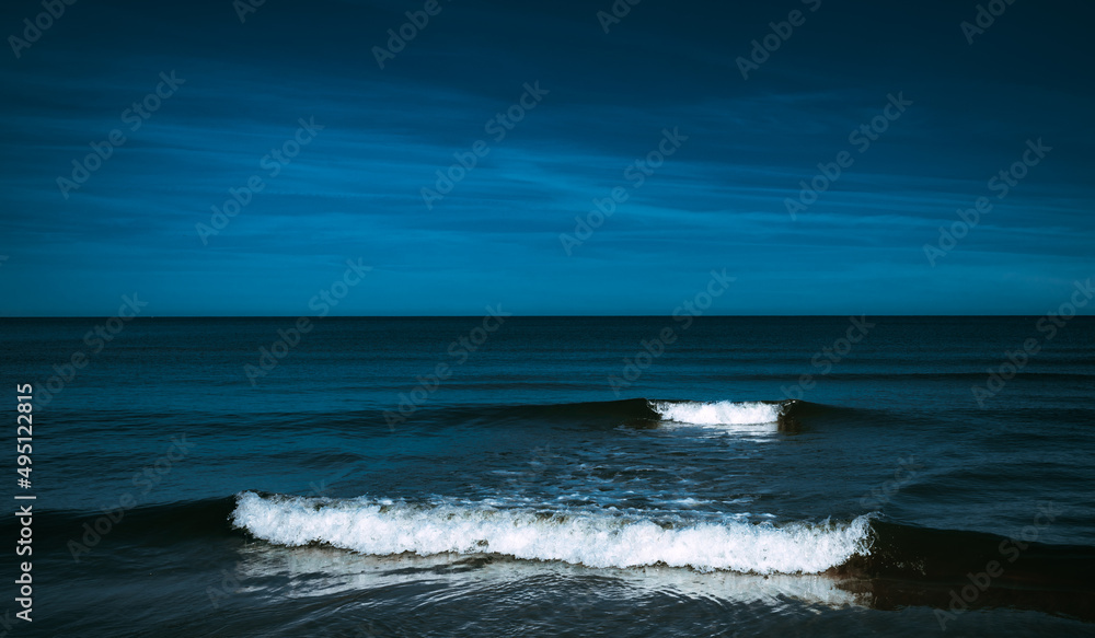 Calm night seascape with white waves Calm night seascape with white waves