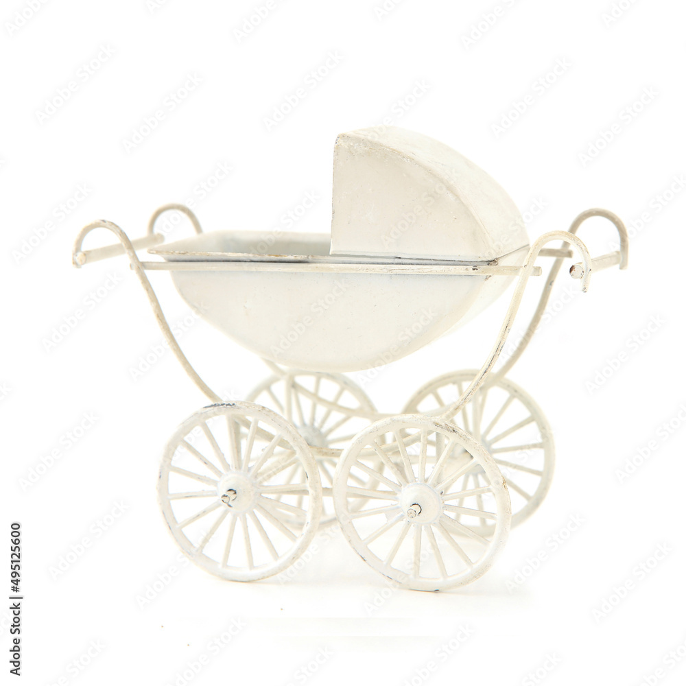 Mini decorative baby stroller isolated on white background. Miniature decor retro baby carriage.