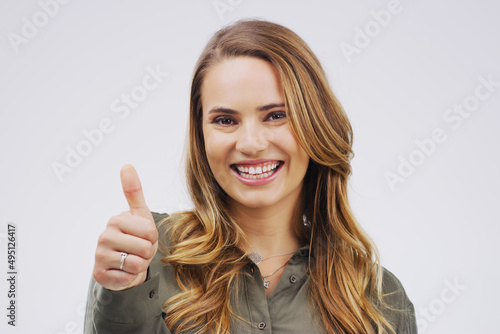 Wallpaper Mural I approve. Studio portrait of an attractive young woman giving a thumbs up against a grey background. Torontodigital.ca