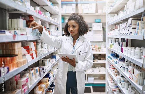 Never fear, your pharmacist is here. Cropped shot of an attractive young female pharmacist working in a pharmacy. photo