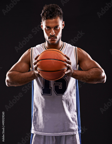 You want to challenge me. Studio shot of a basketball player against a black background. © Duncan M/peopleimages.com