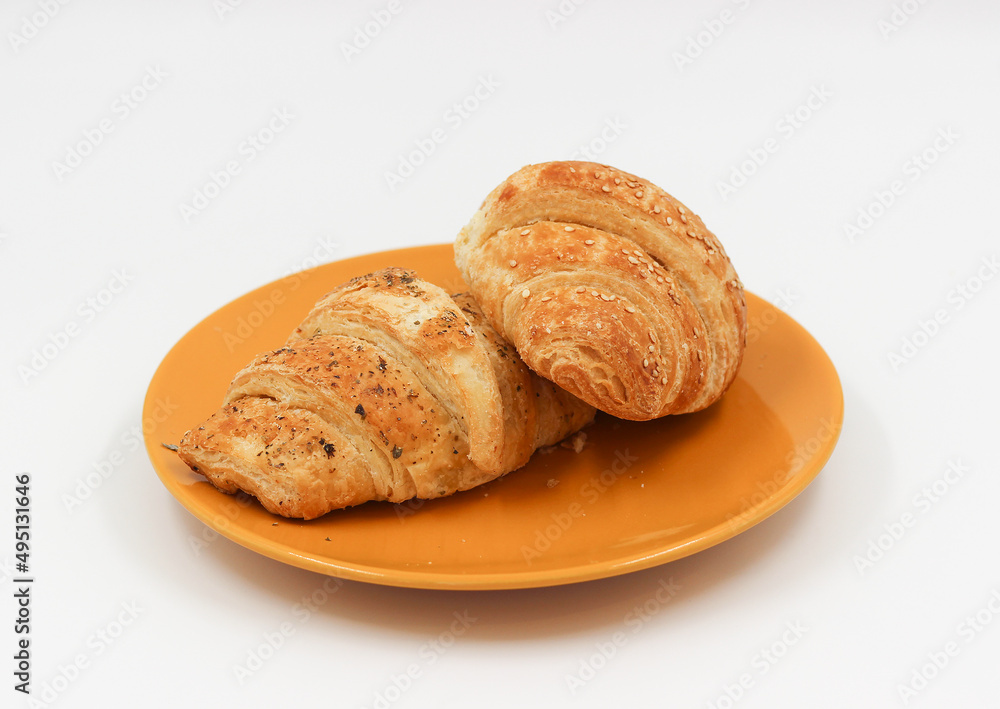 Delicious croissants on the plate with the white background