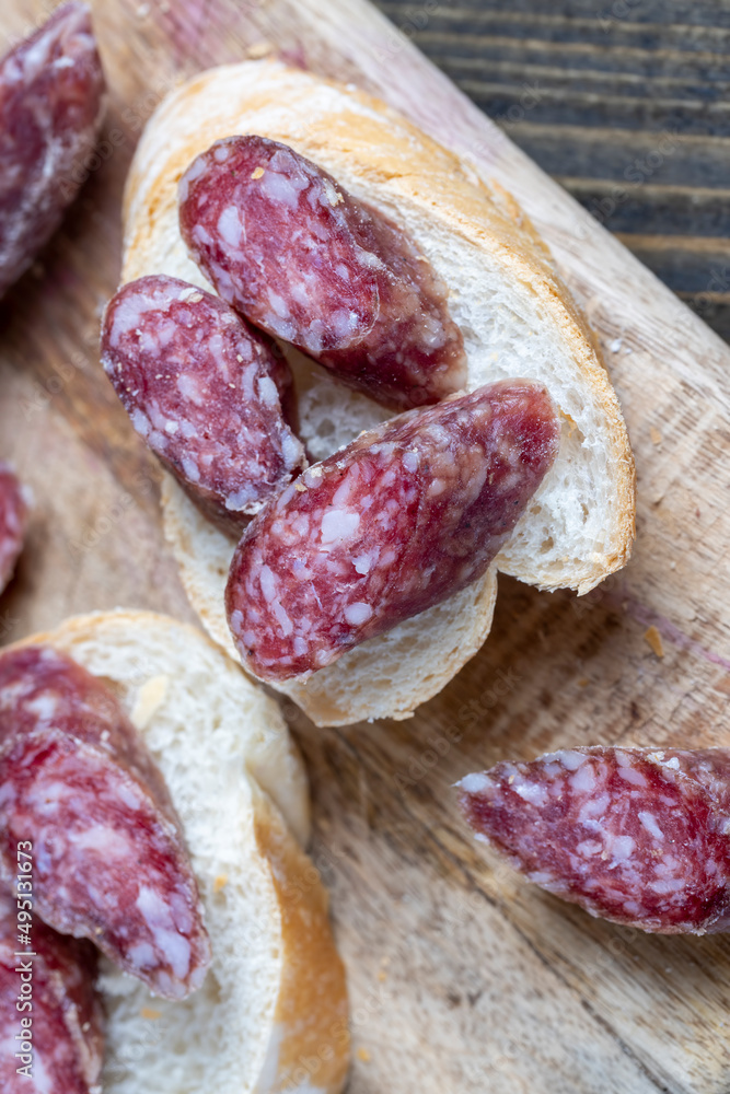 sliced pieces of sausage from meat are lying on a cutting board