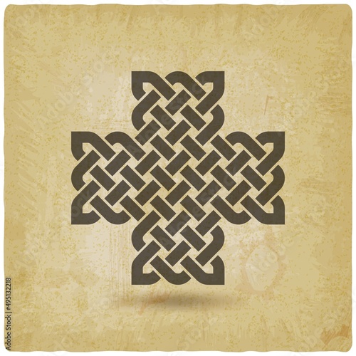 Celtic weaving in shape of cross on vintage background