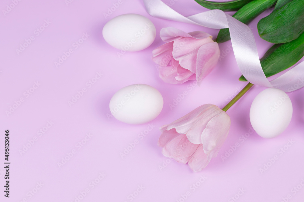 Easter holiday background with white chicken eggs and pink tulip flowers on pink background. Congratulatory Easter background with copy space. Easter holiday background with white chicken eggs and pink tulip flowers on pink background. Congratulatory Easter background with copy space.