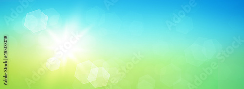 Fresh spring abstract background with glowing sun and hexagonal bokeh. Graphic element with blue and green colour gradients. © Martin Piechotta