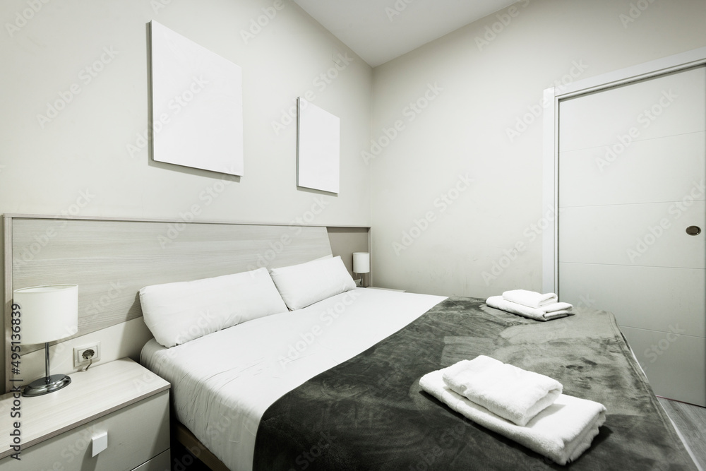 Bedroom with double bed with courtesy blanket and towels in a vacation rental apartment Bedroom with double bed with courtesy blanket and towels in a vacation rental apartment