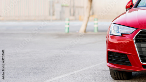 Headlight of a modern red car with blurred background © EmilioZehn