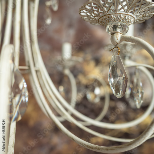 Vintage chandelier, curls, metal candlesticks close-up on a brown background. High quality photo