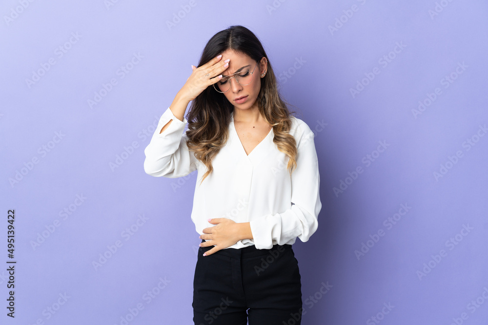 Young caucasian woman isolated on purple background with headache