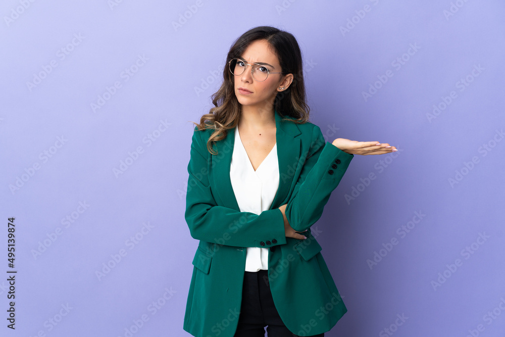Young caucasian woman isolated on purple background having doubts Young caucasian woman isolated on purple background having doubts