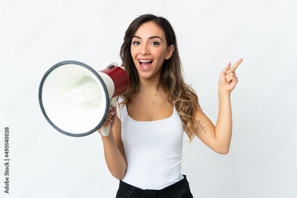 Young caucasian woman isolated on white background shouting through a megaphone and pointing side