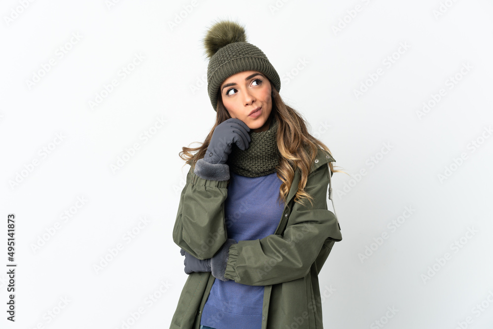 Young girl with winter hat isolated on white background having doubts and thinking Young girl with winter hat isolated on white background having doubts and thinking