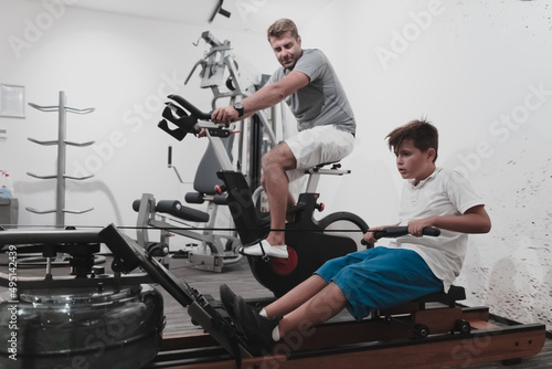 Father and son train together at home gym. The concept of healthy life. Selective focus