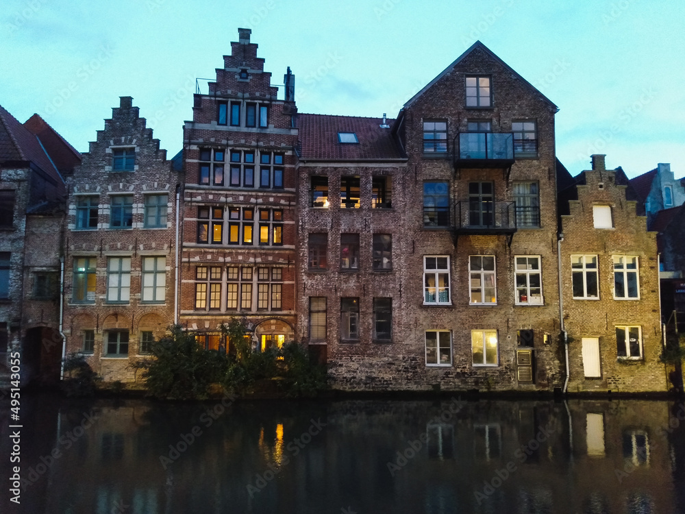 The medieval architecture of Ghent in Belgium illuminated in the evening