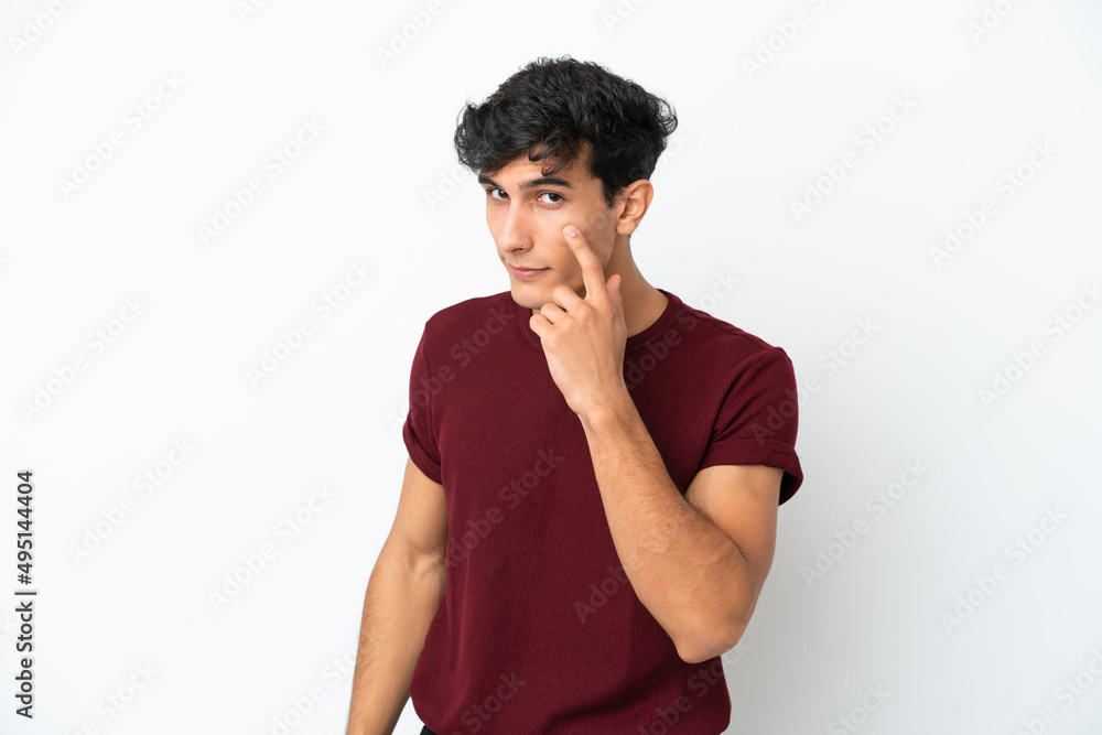 Young Argentinian man isolated on white background showing something Young Argentinian man isolated on white background showing something