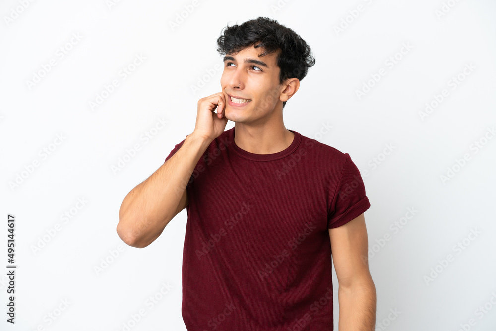 Young Argentinian man isolated on white background is a little bit nervous Young Argentinian man isolated on white background is a little bit nervous