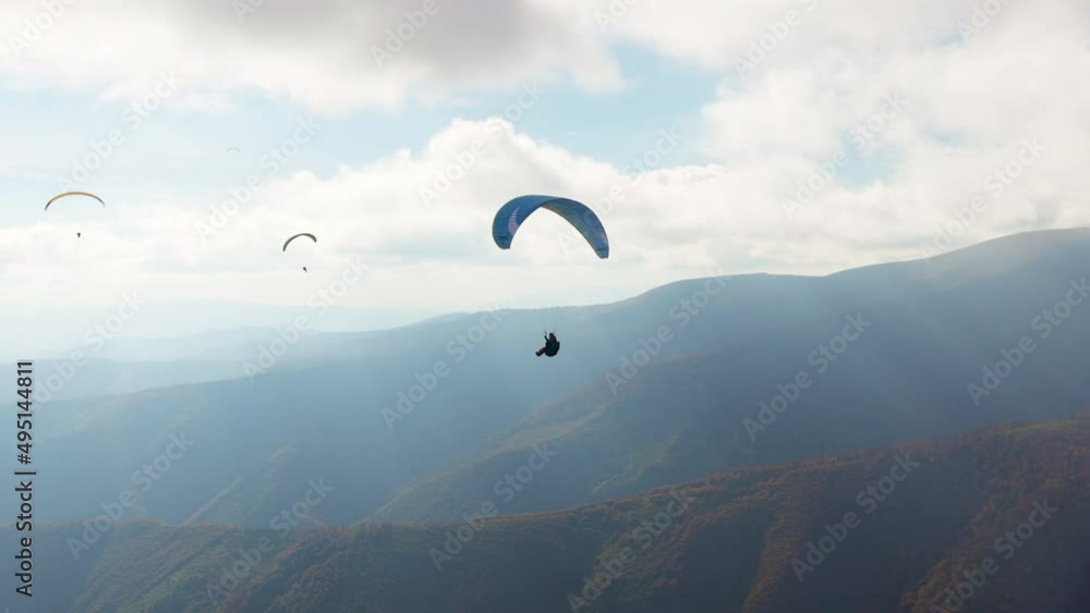 Paragliding active sport against giant mountains in highland Paragliding active sport against giant mountains in highland