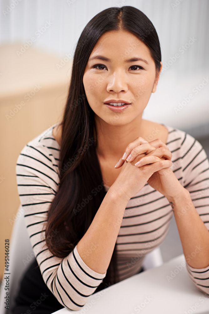 Shes sure to succeed. Portrait of a confident young asian businesswoman sitting at her desk. Shes sure to succeed. Portrait of a confident young asian businesswoman sitting at her desk.
