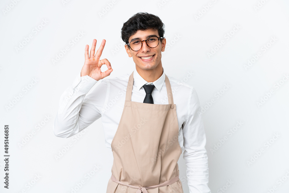 Restaurant Argentinian waiter isolated on white background showing ok sign with fingers Restaurant Argentinian waiter isolated on white background showing ok sign with fingers