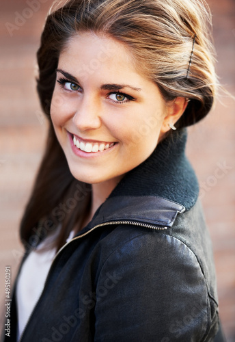 Flashing a candid smile. Portrait of an attractive young woman outdoors in the city.