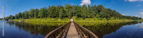 view of the pontoon pedestrian bridge across the Gauja river, Ogre, Latvia.. Reflection of the forest in the water of the river. panoramic photo photo