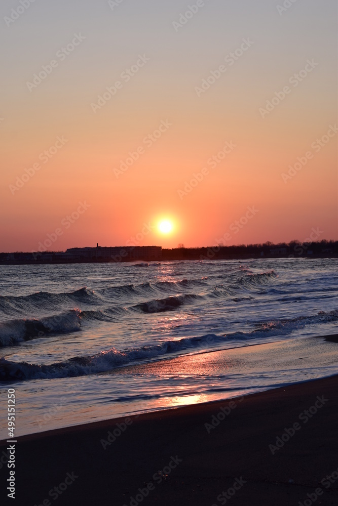 Sunset sea landscape. Warm March day, calm sea.