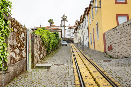 a cobbled street with tram tracks (Calçada Viriato) with a view to Misericordia Church in Viseu, province of Beira Alta, Portugal photo