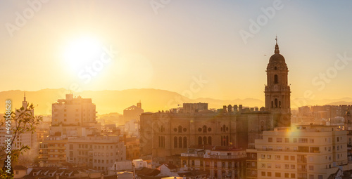 Sunset from the walls of the Alcazaba of the city of Malaga and in the background the Cathedral of the Incarnation of Malaga  Andalusia. Spain. Medieval fortress in arabic style