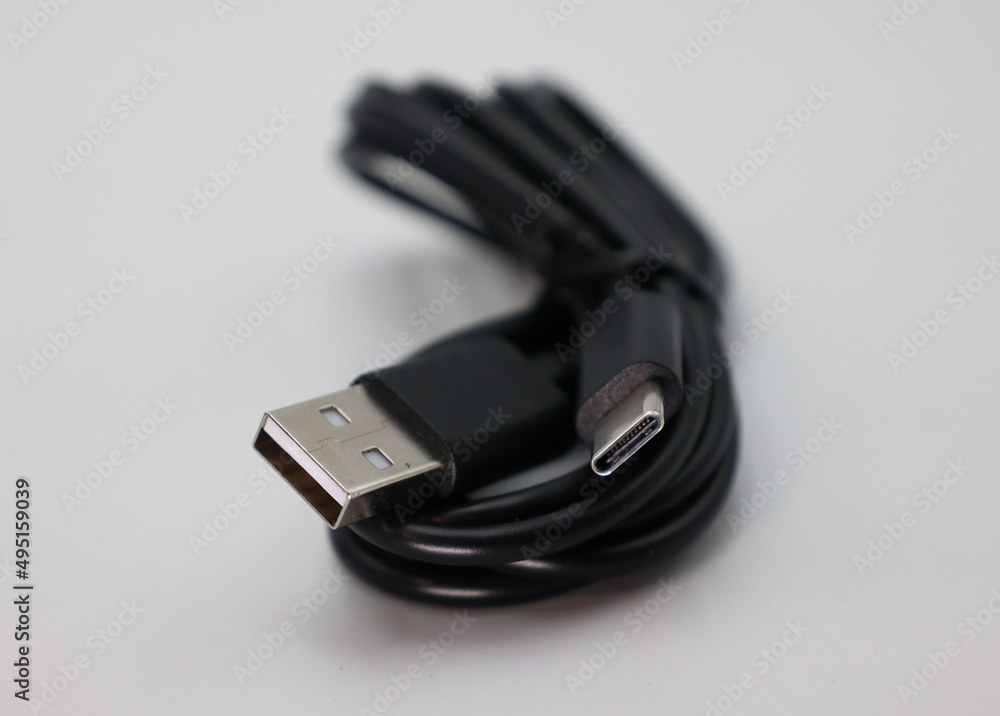 A cable wrapped up in front of a white background. The cable is USB C but is lower speed. A cable wrapped up in front of a white background. The cable is USB C but is lower speed.