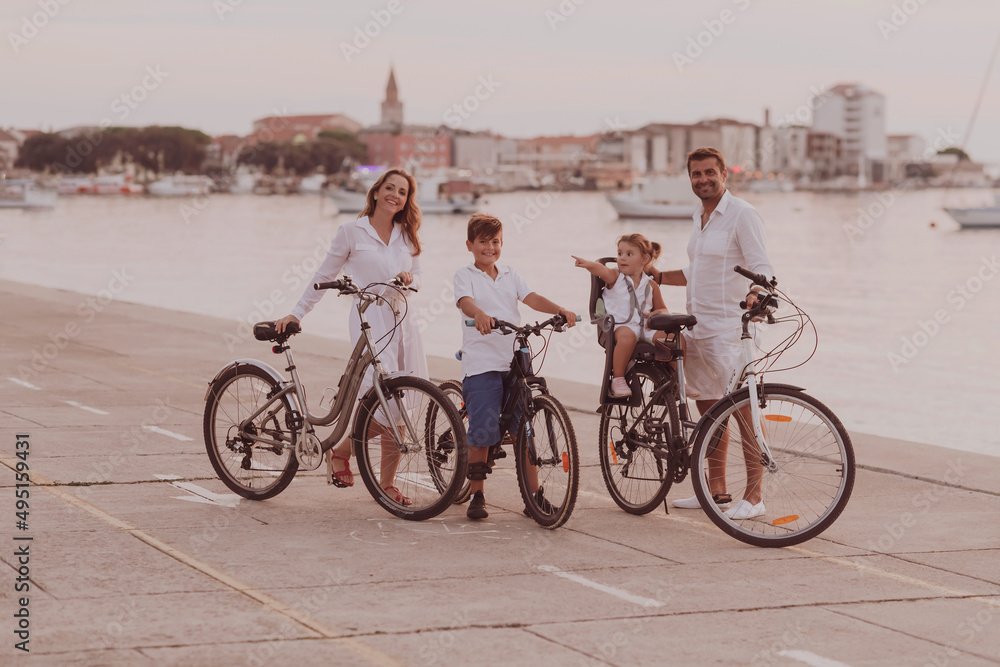 The happy family enjoys a beautiful morning by the sea riding a bike together and spending time together. The concept of a happy family
