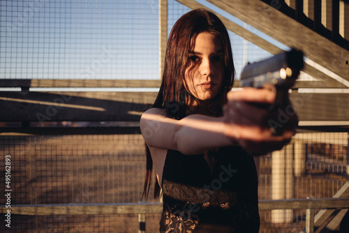beautiful woman with guns in her hands photo
