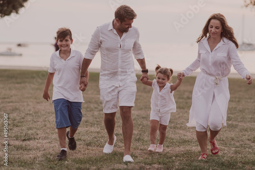 Senior couple in casual clothes with their children, boy and girl enjoy the beach spending a vacation together. Family time . Selective focus 