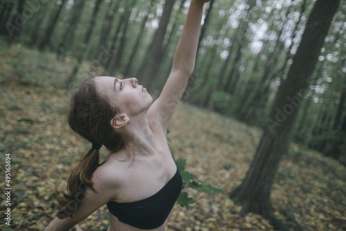 ballet dancer in the forest wear black