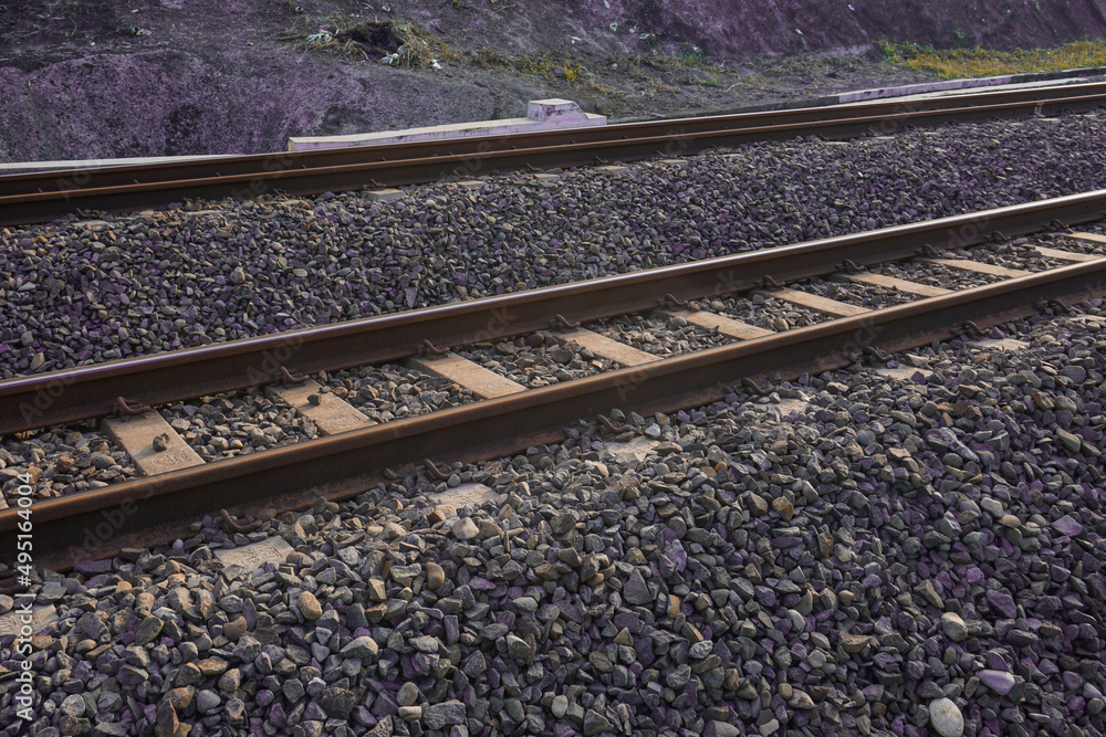 The railroad tracks pass through the grooved bearings buried under the shards of cobblestone The railroad tracks pass through the grooved bearings buried under the shards of cobblestone
