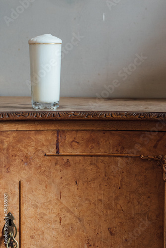 Ramos gin fizz milkshake white foam in gold-rimmed tall glass © Nicole Kandi