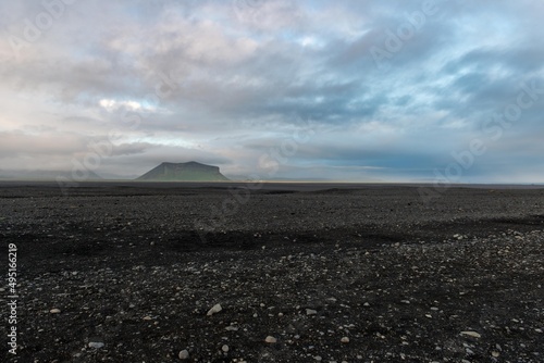 Black sand beach with mountain