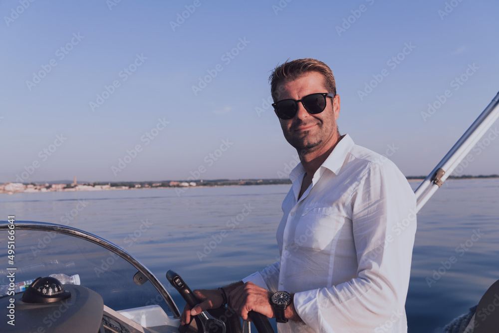 custom made wallpaper toronto digitalA determined senior businessman in casual clothes and sunglasses enjoys his vacation driving a luxury boat at sunset. Selective focus