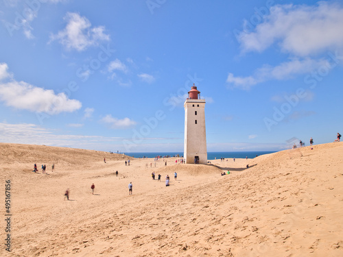 Old lighthouse "Rubjerg Knude Fyr" with sand dunes and cliffs in Denmark at North Sea