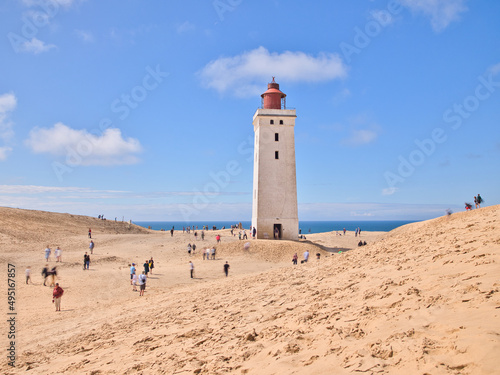 Old lighthouse "Rubjerg Knude Fyr" with sand dunes and cliffs in Denmark at North Sea