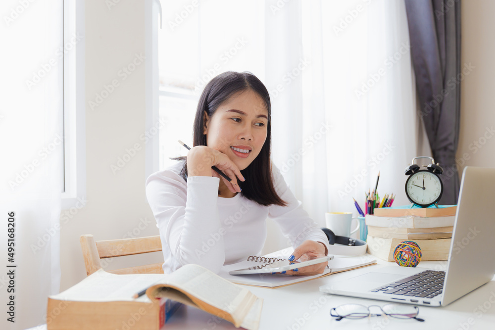 Asian girl student studying in her home office using laptops and online learning. Asian girl student studying in her home office using laptops and online learning.
