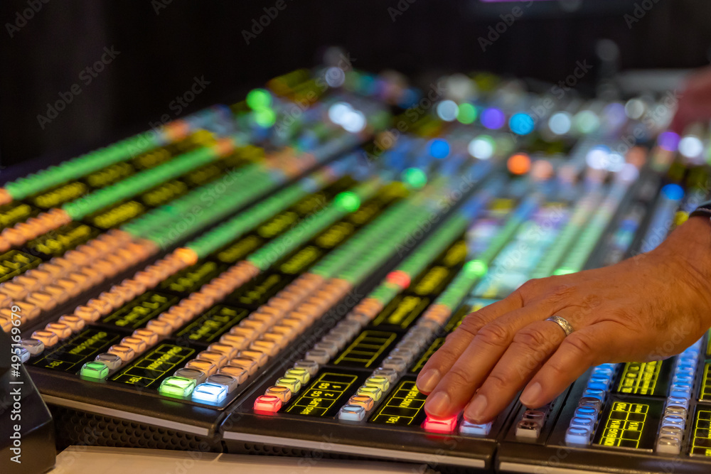 Technicians hands working on a video switcher Technicians hands working on a video switcher