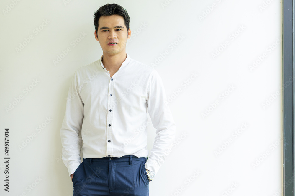The handsome and friendly young man had a happy and confident positive smile on his face. Ideas for young men with good attitude young businessman standing alone on a white background The handsome and friendly young man had a happy and confident positive smile on his face. Ideas for young men with good attitude young businessman standing alone on a white background