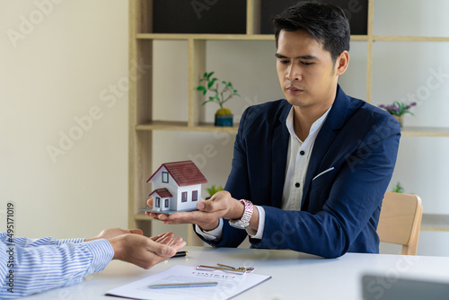 The home sales representative offers a list of home prices and conditions for buying or renting a home on the workspace table in the new home. Moving and hunting ideas
